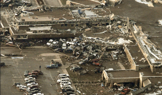 The Moore Medical Center was impacted directly by the probable EF5 tornado. Dozens of cars in the adjoining parking lot were piled against the structure's western wing. (Image by Steve Gooch)