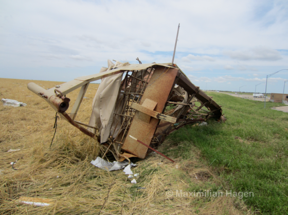 A livestock trailer was blown 300 yards to the south from a complex across the highway and left tangled in the remains of a fence.